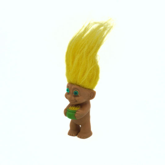 Toy figure with yellow hair on a white background