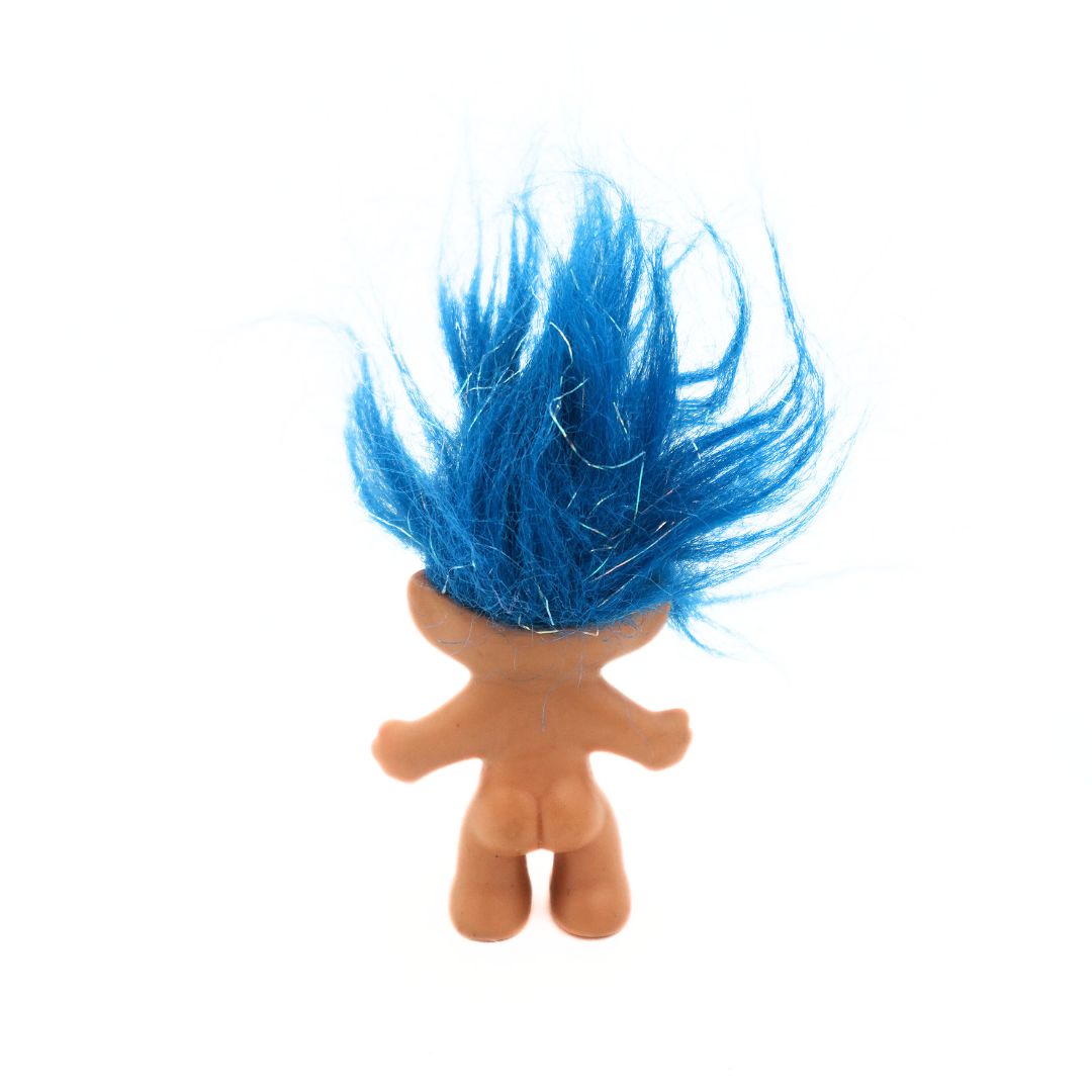 A 90s Sparkling Good Luck Troll doll released by Russ with blue hair with tinsel detailing