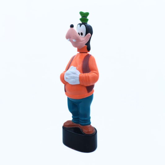 Cartoon character figurine with an orange shirt and blue pants on a white background