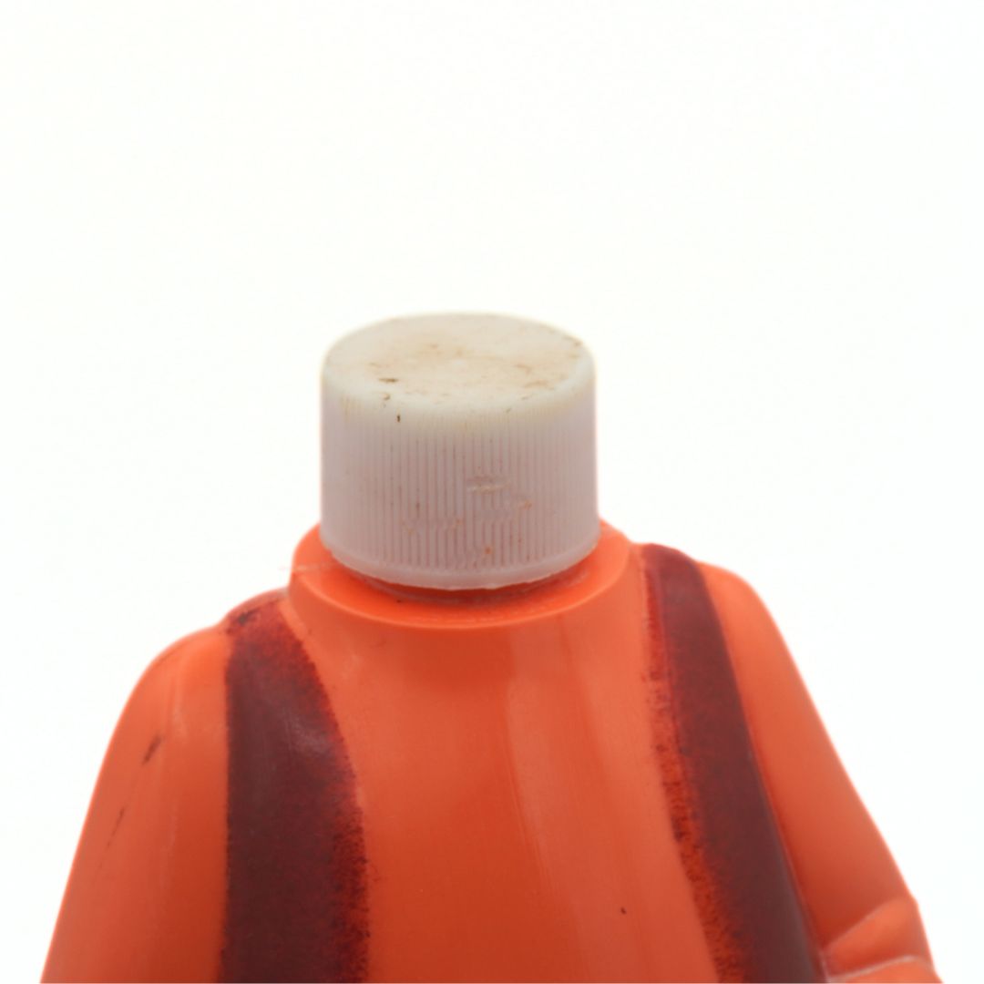 Close-up of an orange bottle with a white cap on a white background