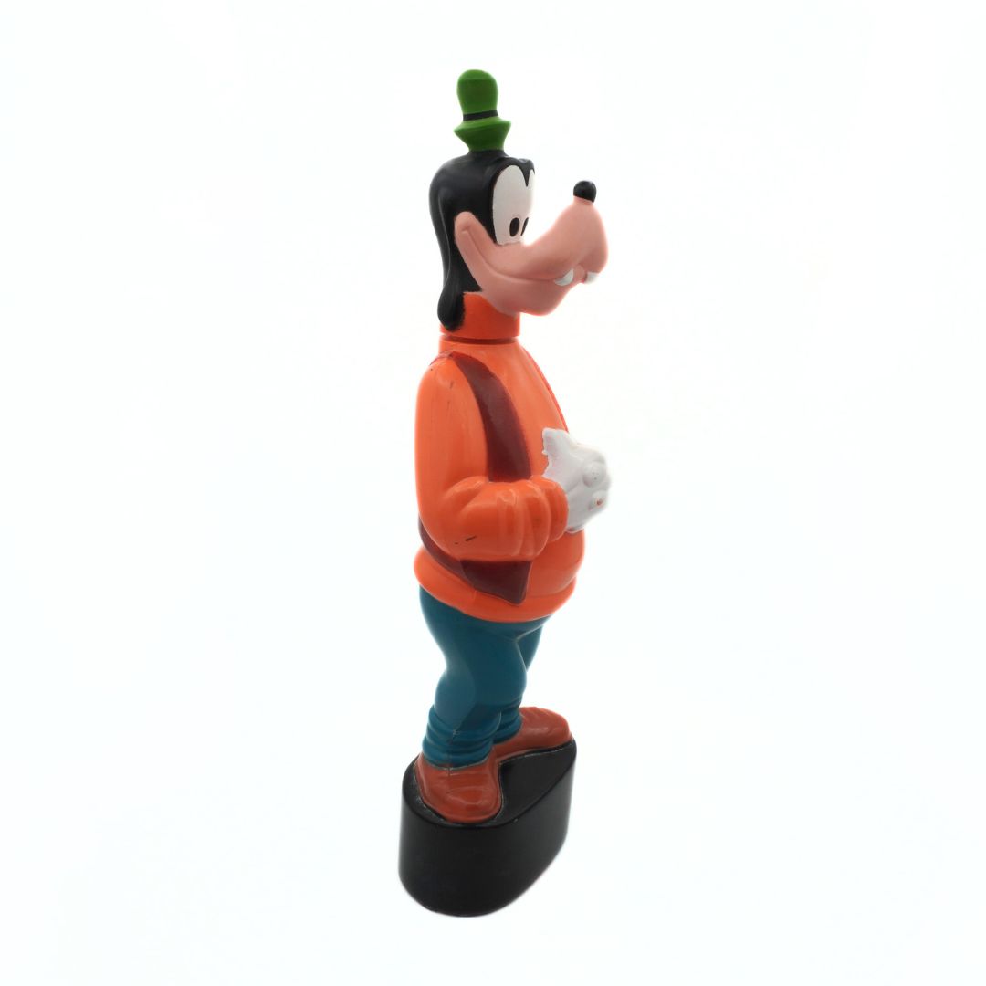 Cartoon character figurine wearing an orange sweater on a white background
