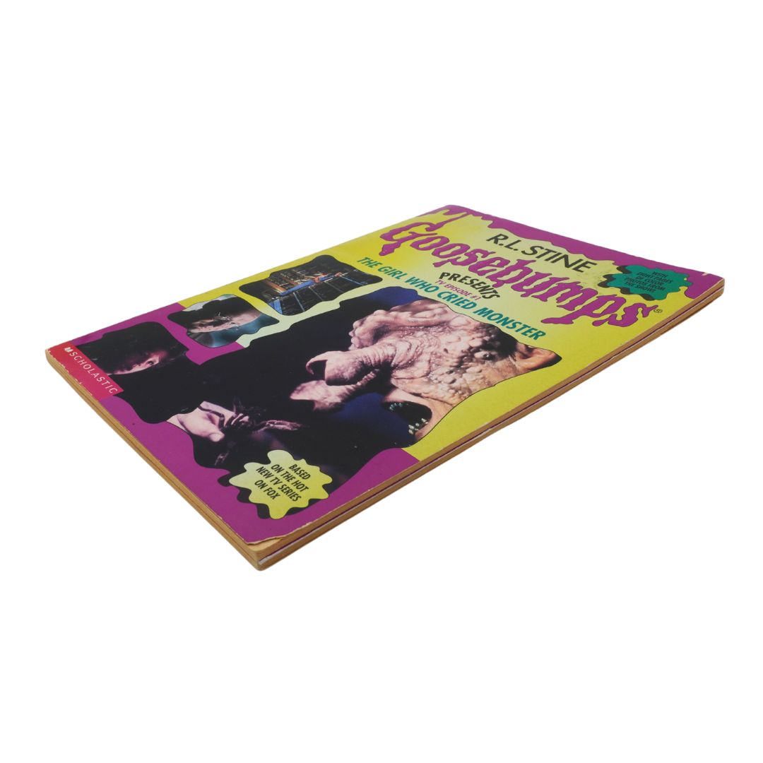 Goosebumps book with colorful cover featuring a black and white dog illustration on a white background