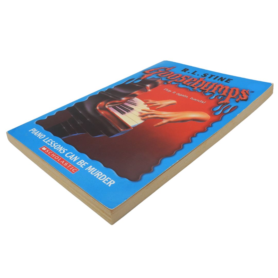 Side of a vintage blue and red Goosebumps book on a white background