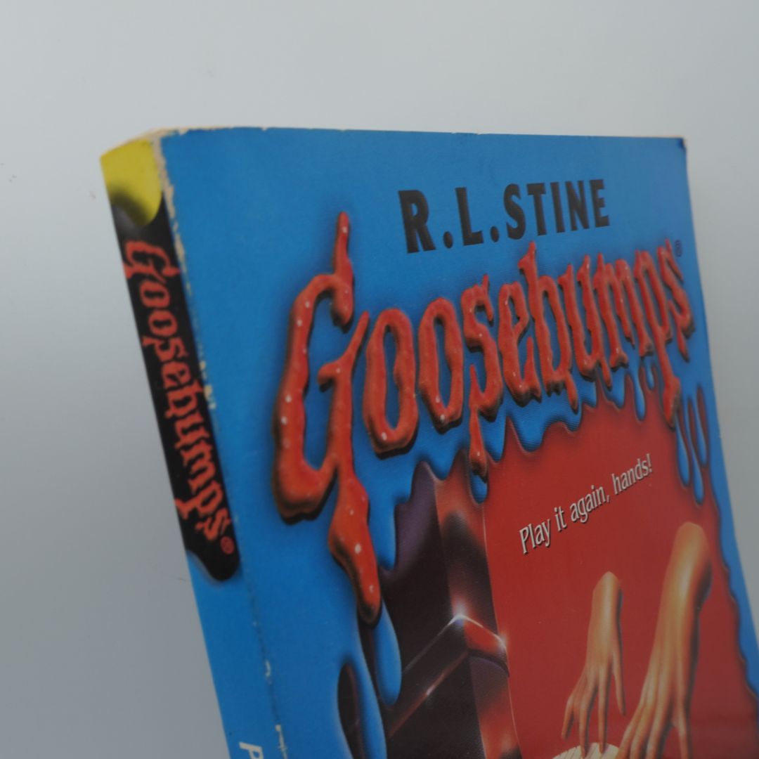 Spine of a vintage Goosebumps book showing some wear and damage