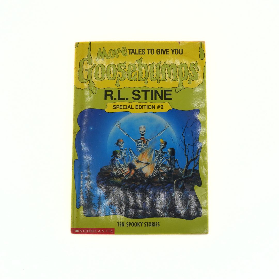 Goosebumps book with skeletons on a hill and blue sky