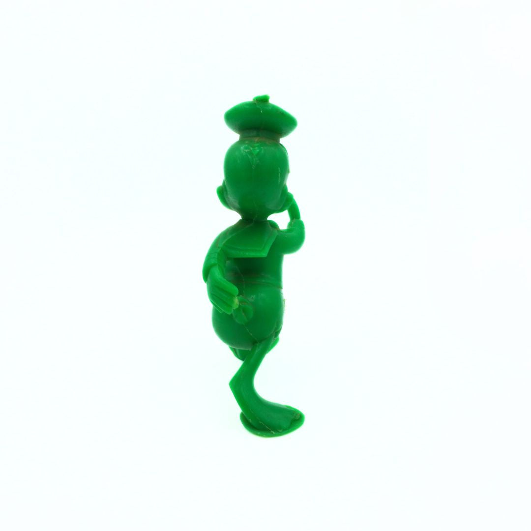 Green character figurine on a white background