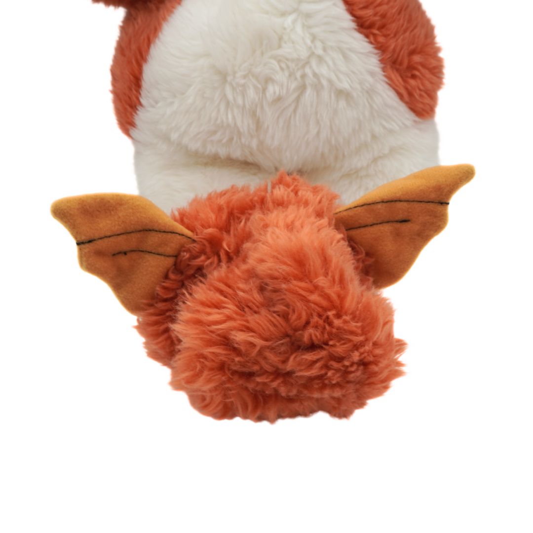 Close-up of a plush toy with a white face and orange ears on a white background