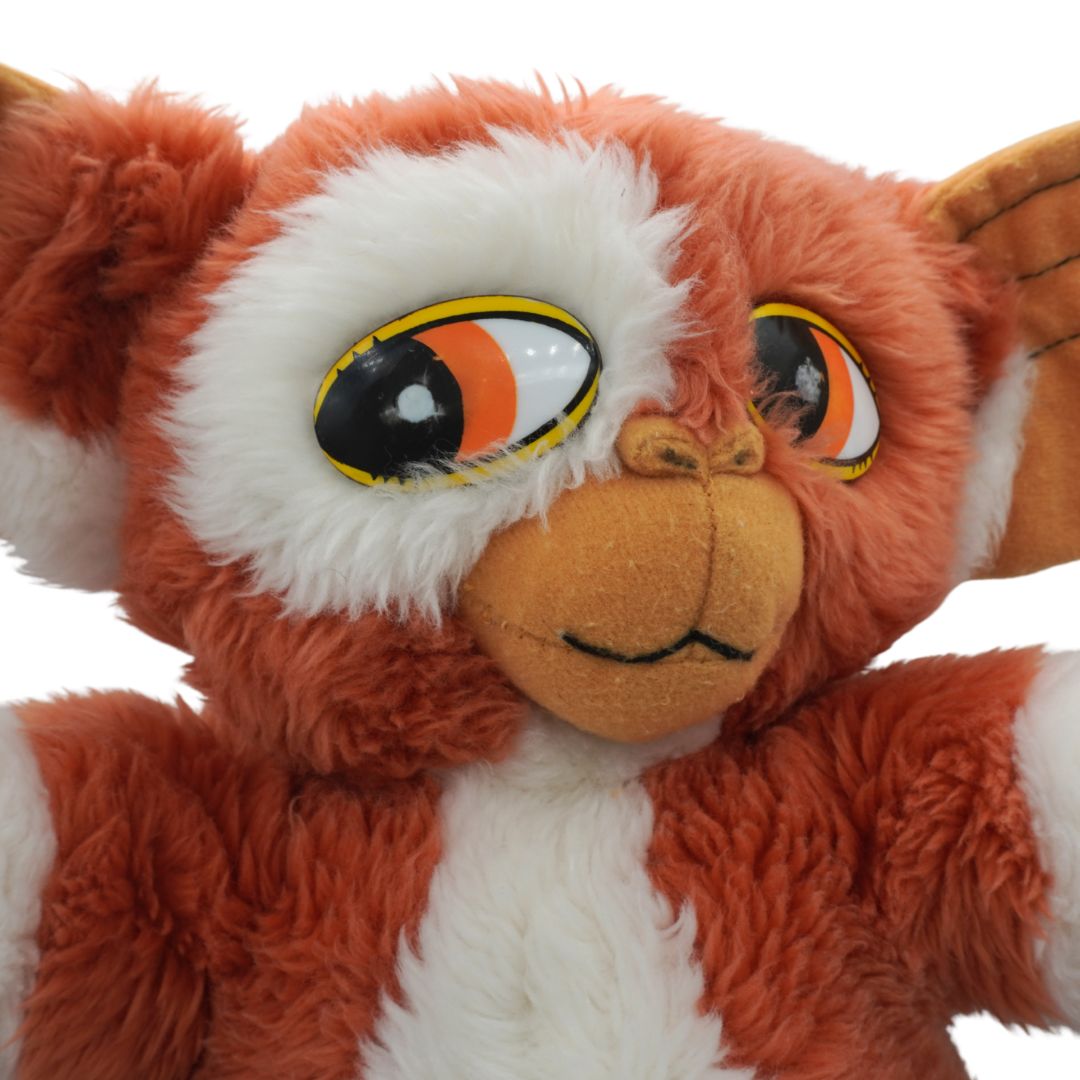 Close-up of a plush toy with orange and white fur on a white background