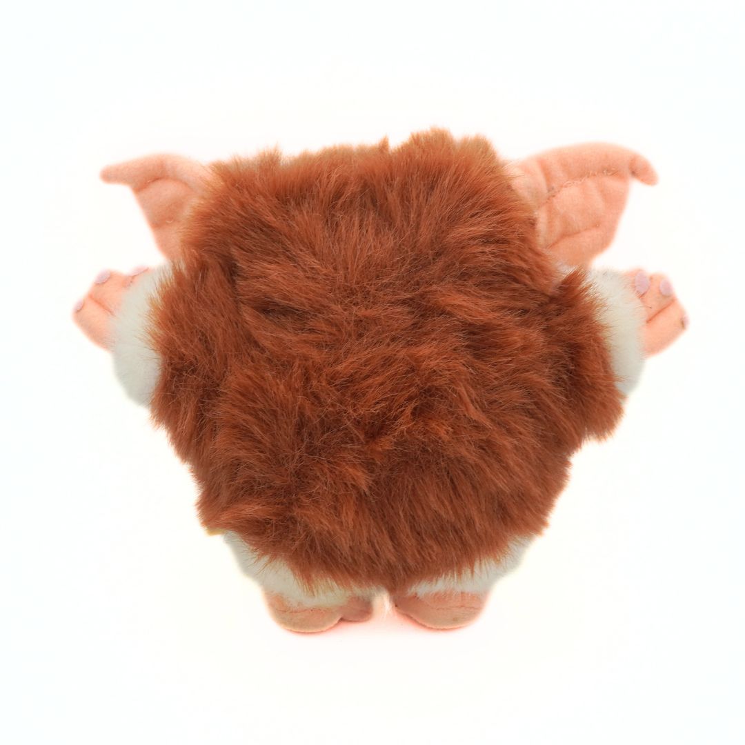 Plush toy with brown fur and pink ears on a white background