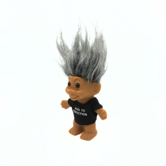 Grey haired Russ troll doll with an Aged to Perfection t-shirt