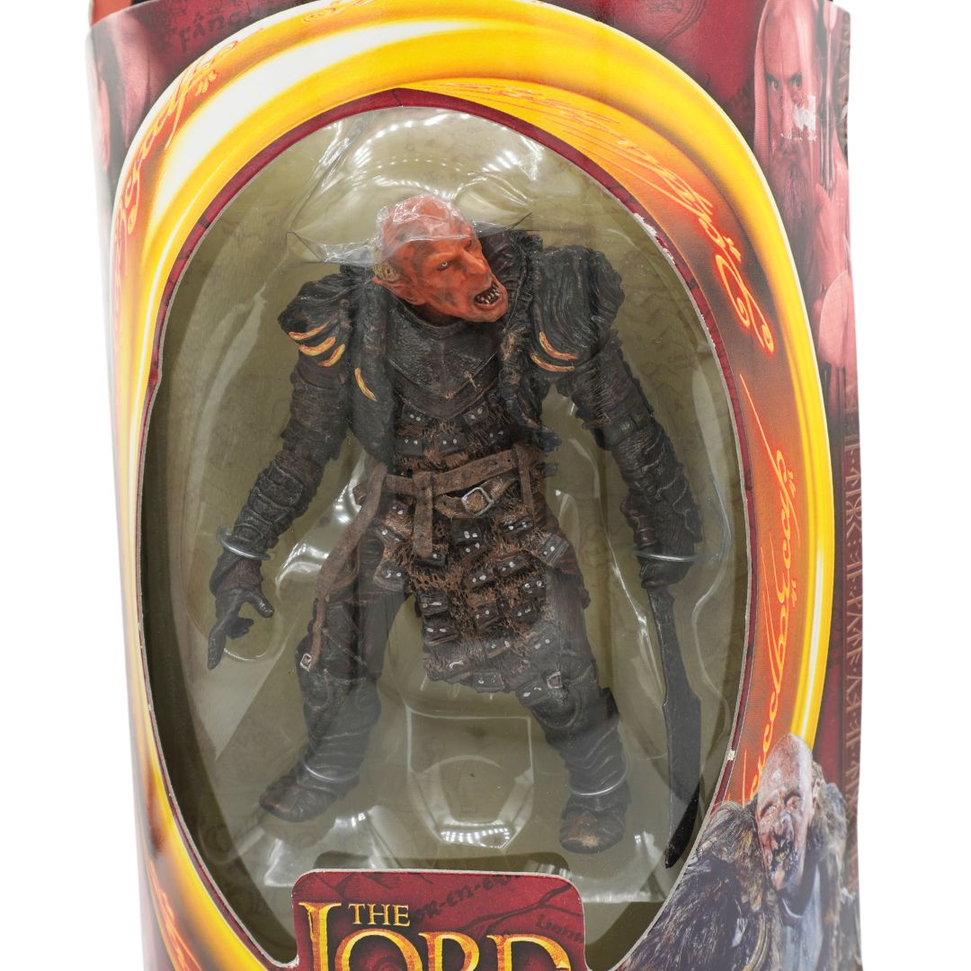 A front on photo of Grishnakh from Lord of the Rings in red and yellow packaging on a white background