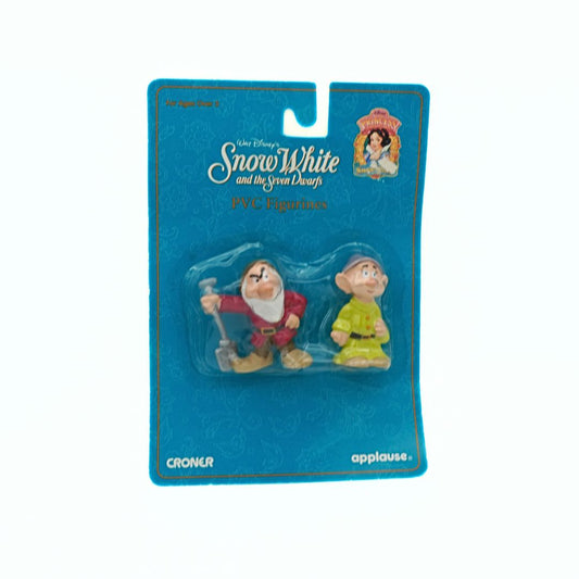 Two small figures in packaging with 'Snow White and the Seven Dwarfs' branding on a blue background.
