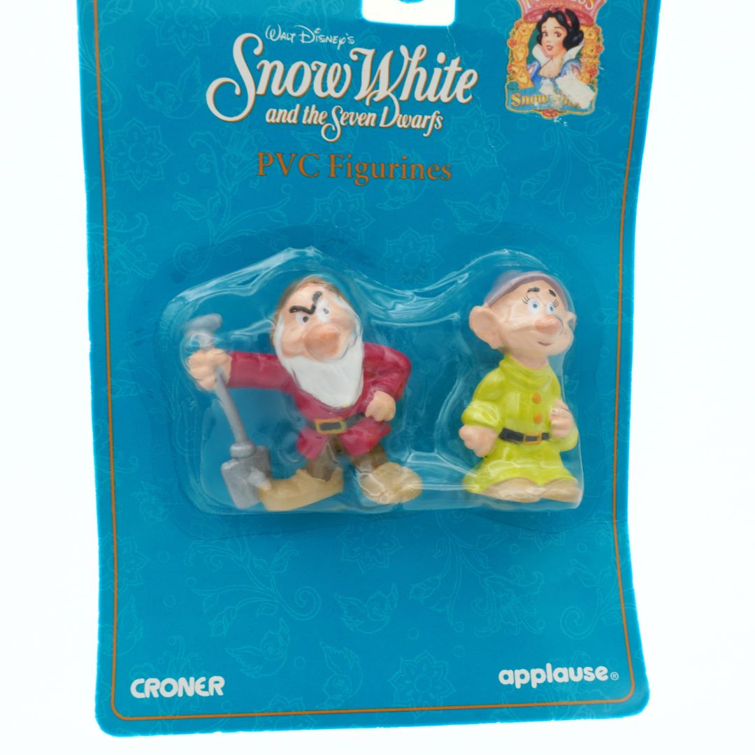Packaged Disney Snow White and the Seven Dwarfs PVC figurines with blue background