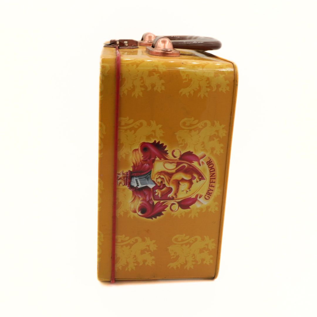 Yellow metal canister with a lion logo on a white background