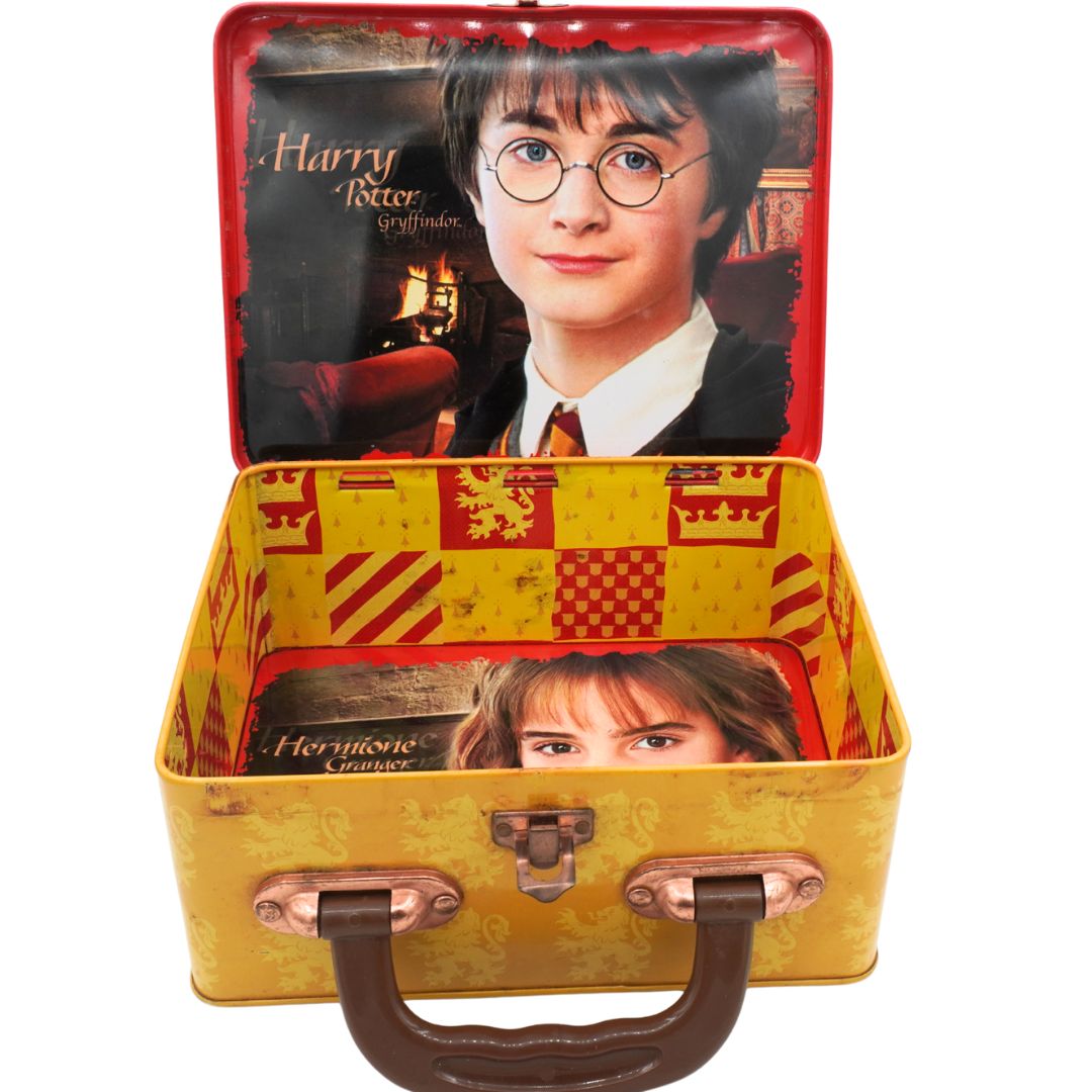 Yellow lunchbox with images of Harry Potter and Hermione Granger on a white background