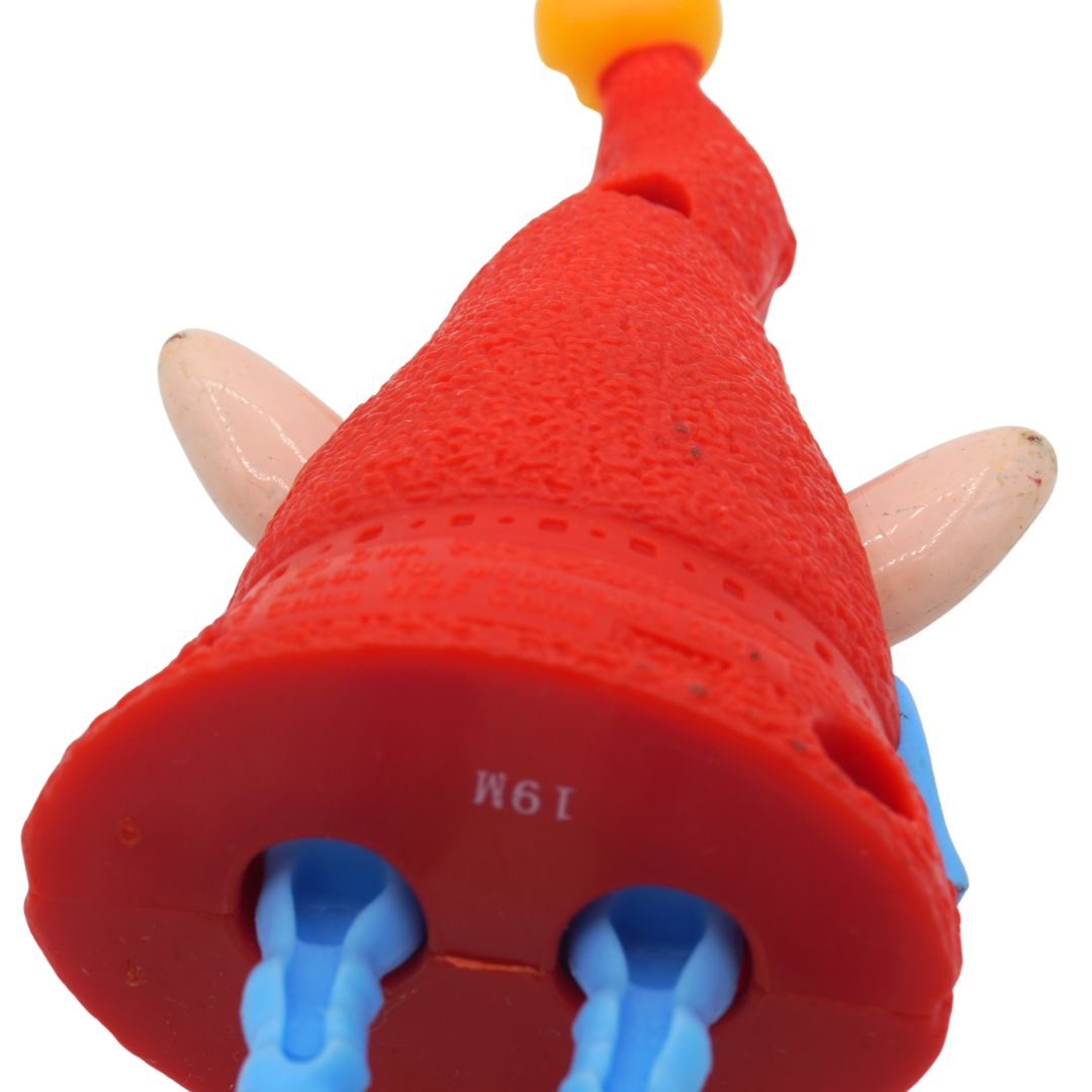 Red plastic toy with blue handles and a yellow top on a white background