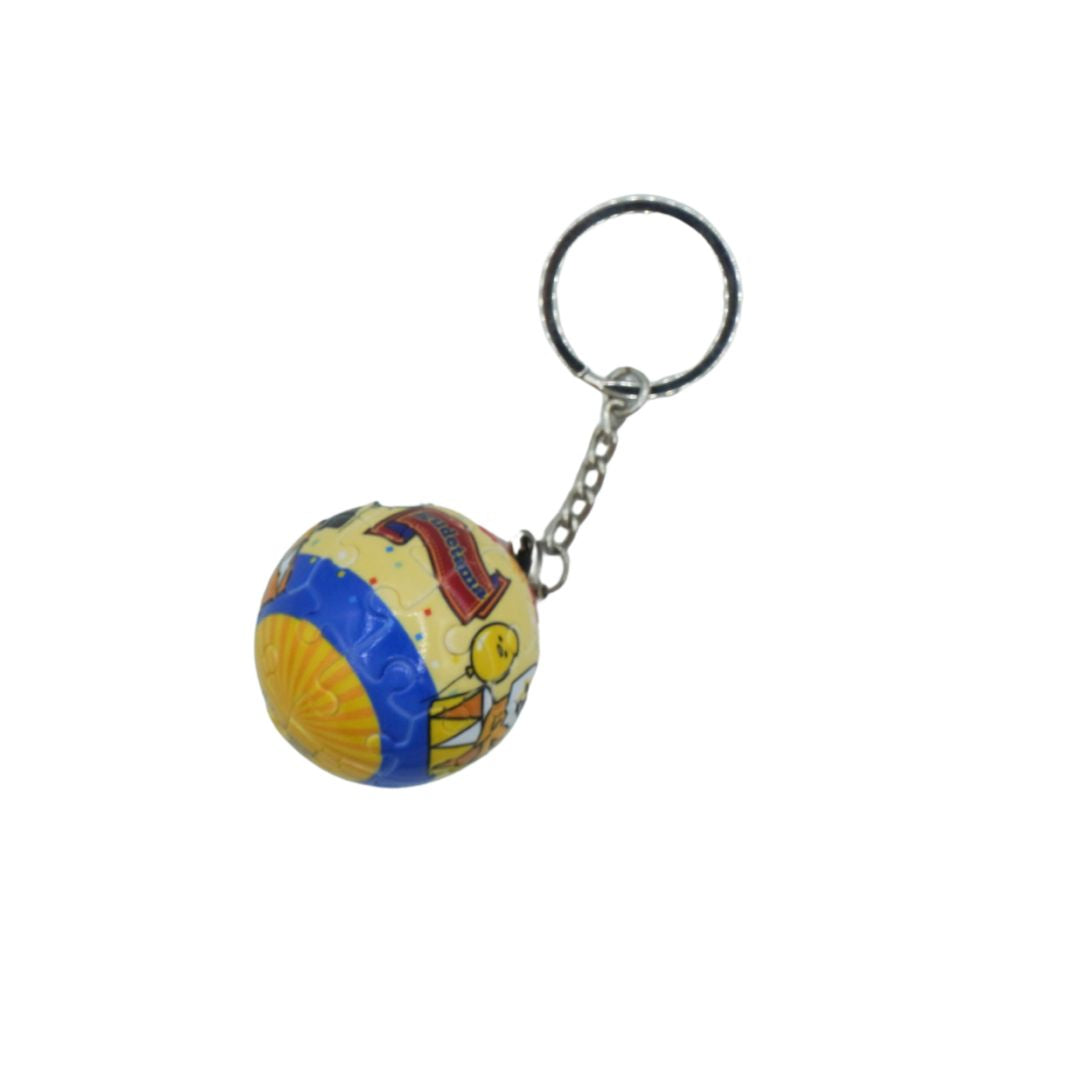 A small spherical keychain charm featuring a colorful vintage-style circus or carnival illustration, attached to a silver metal split ring and short chain, shown on a plain white background.