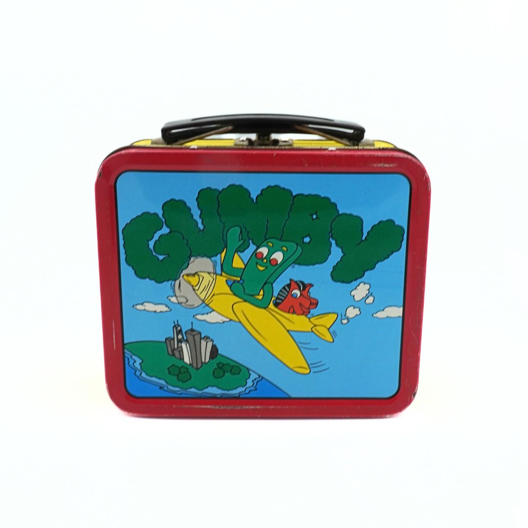 Back of a vintage 90s Gumby lunchbox with a green, yellow, blue and red colour palette featuring Gumby and Pokey in a yellow plane