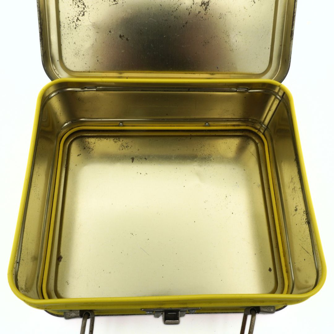 Closeup angle of the gold toned interior of a vintage 90s Gumby metal lunchbox