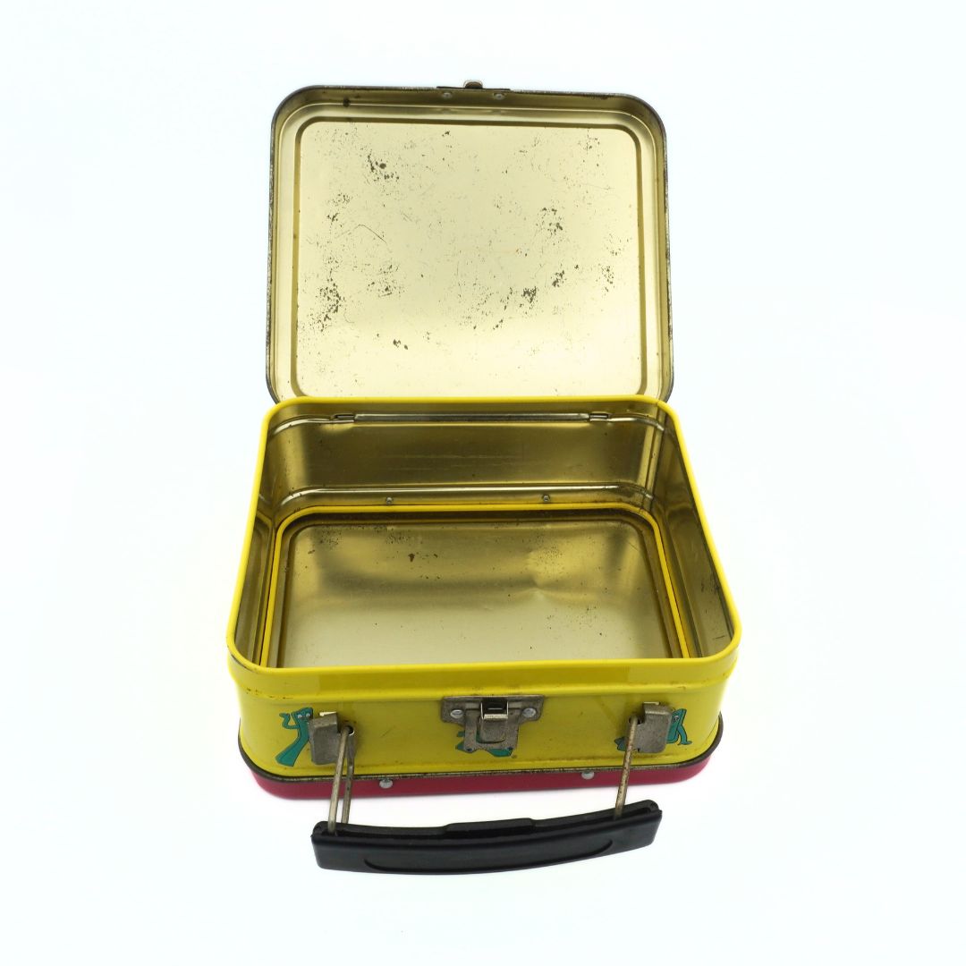 Inside of a vintage 1999 Gumby lunchbox with a gold-toned metal interior