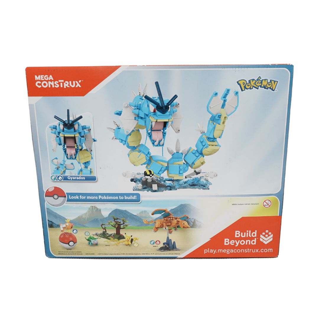 A photo of the back of the Gyarados Mega Construx in box, showing the other collectible items in the range