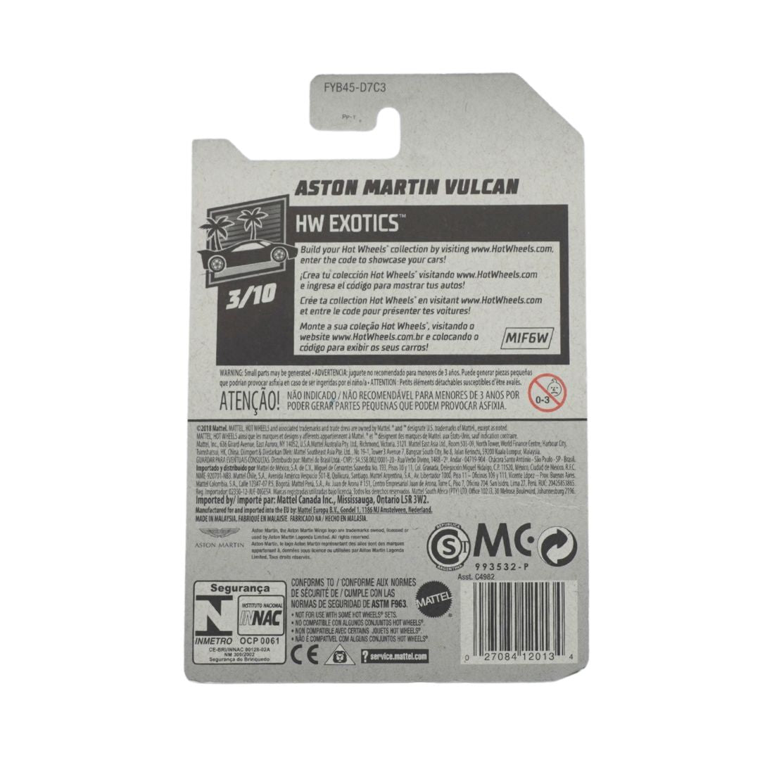 Back of a toy car blister card package for an Aston Martin Vulcan HW Exotics 3/10 scale model, showing product info, warnings, logos, and barcode on a white background.