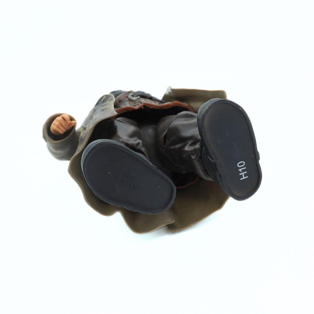 Underside of a 2010 Hagrid figurine with brown pants and black shoes