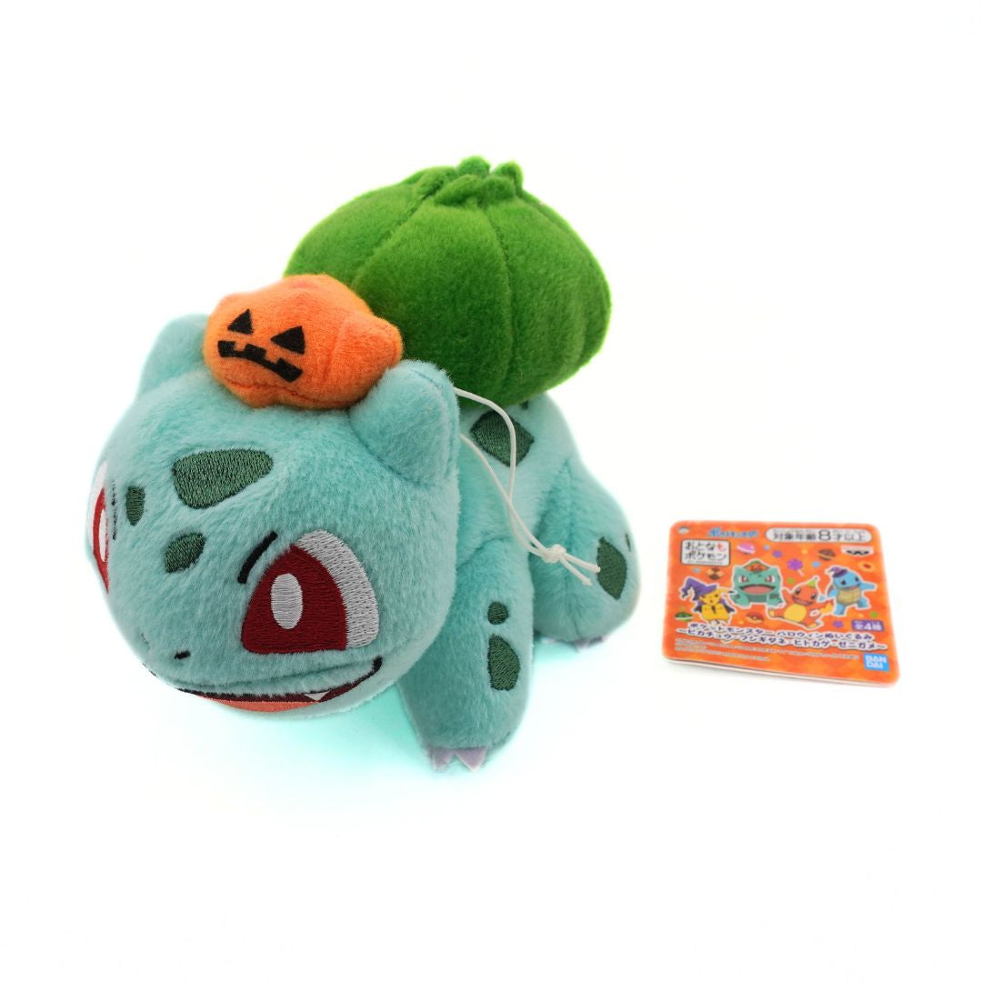 Plush toy resembling a character with a pumpkin on its head, next to a tag with text.