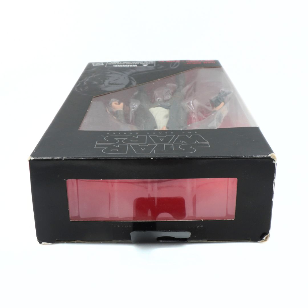 Black box with a clear window containing action figures on a white background