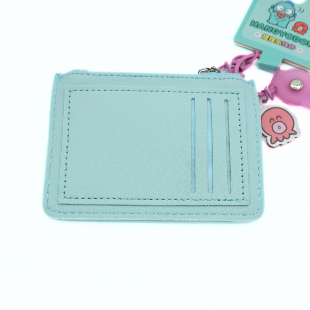 A light blue faux leather card holder wallet with three card slots and a pink keychain attached, shown on a white background.