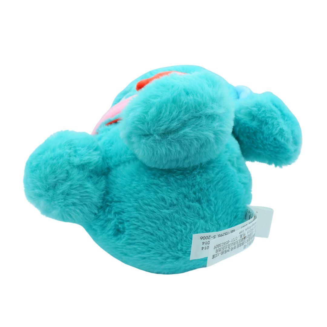 Underside of a blue plush with white tags on a white background