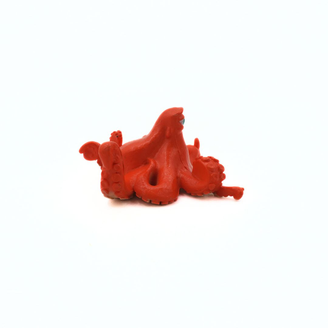Red octopus figurine on a white background