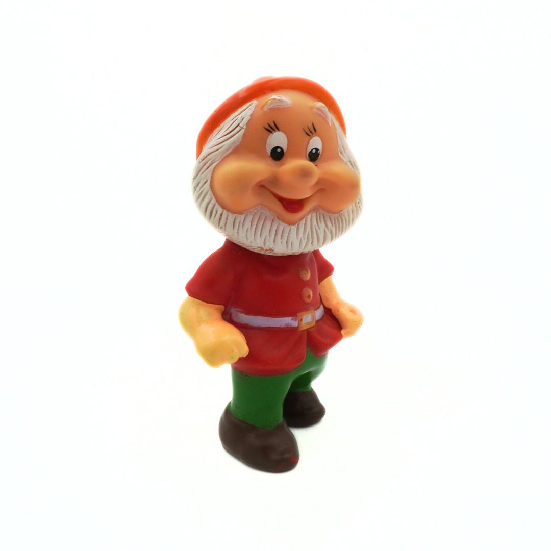 Toy figure of a gnome with a red hat and outfit on a white background