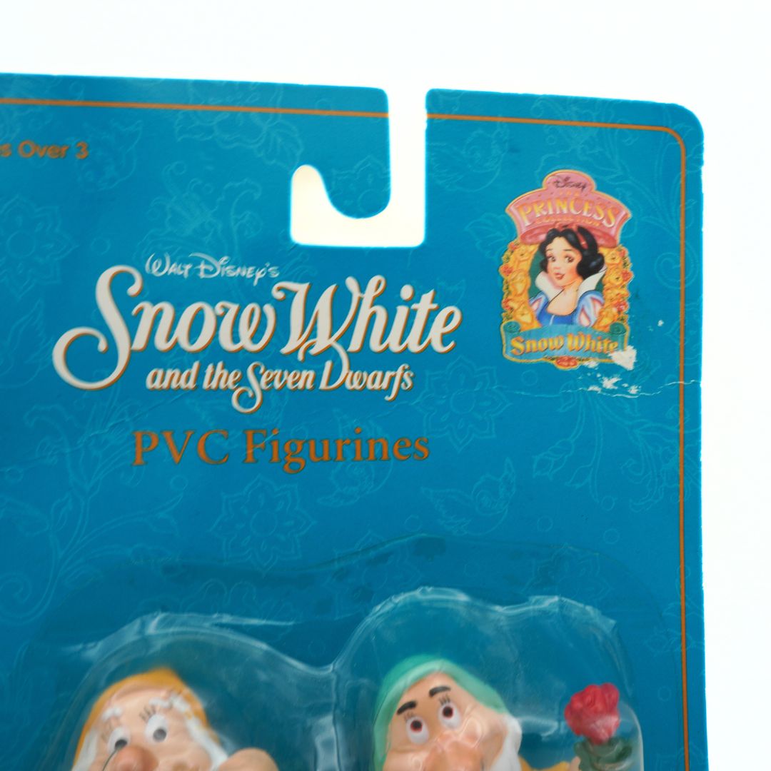 Packaging of Snow White PVC figurines with blue background and Disney logo.