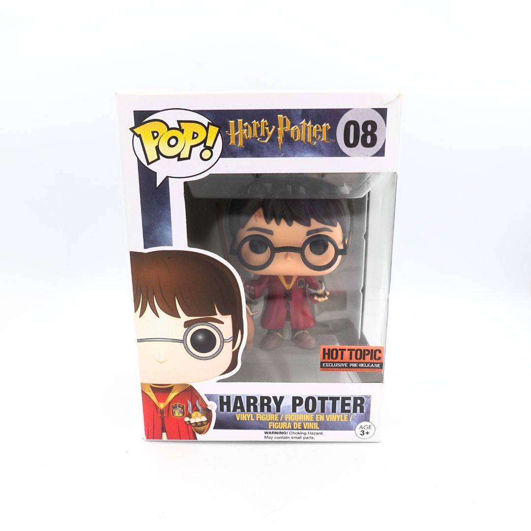 Front on photo of the a Hot Topic Pre-Release Harry Potter 08 Funko Pop in a red Quidditch uniform, holding a broom and a golden snitch