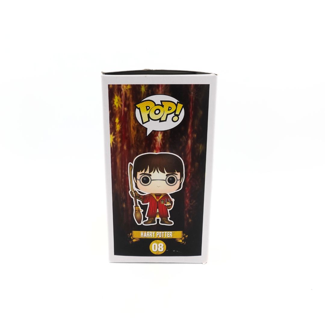 Side on photo of packaging of the Harry Potter 08 Funko Pop in his Quidditch uniform, showing an illustration of the vinyl figure