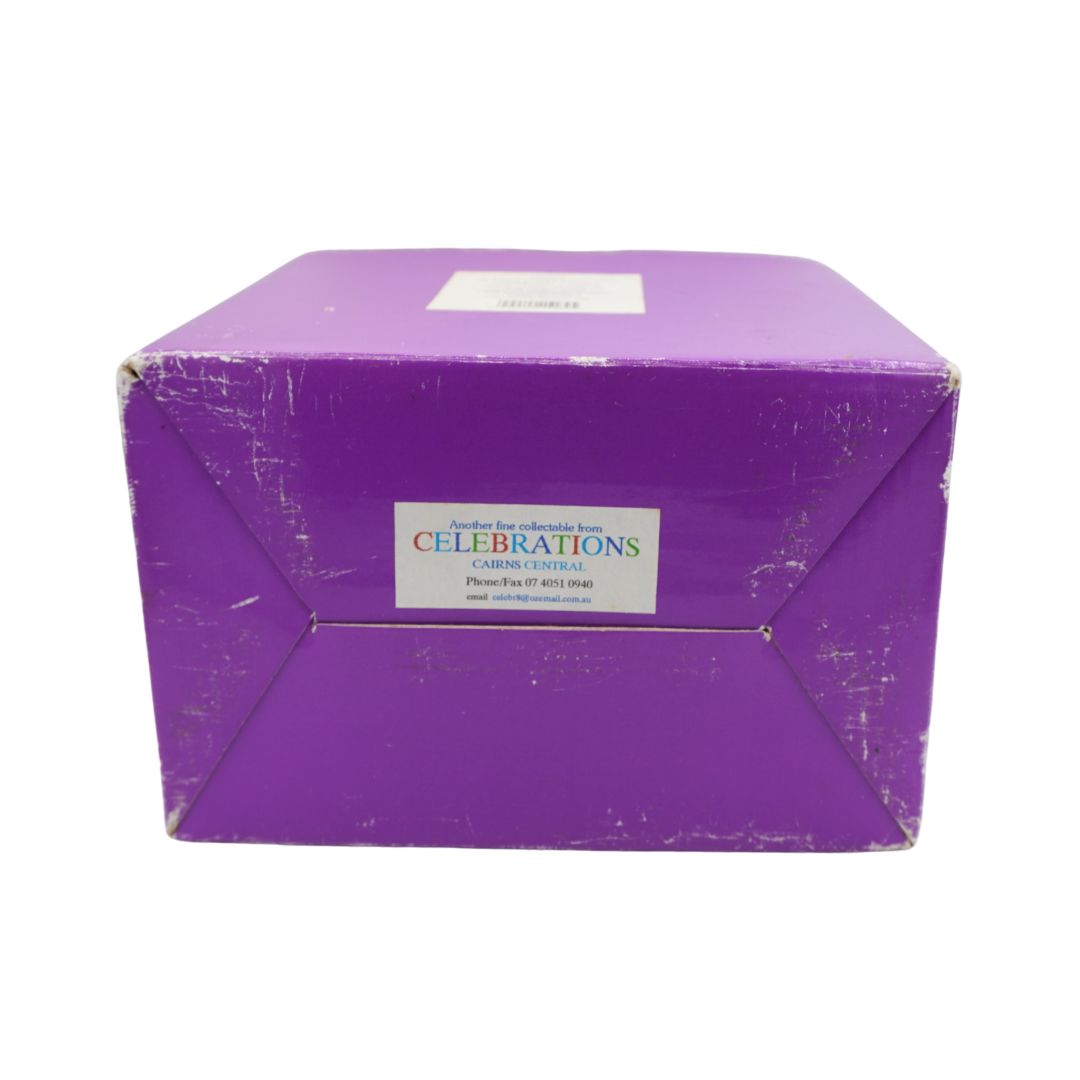 A purple cardboard box with a white label that reads 'CELEBRATIONS' and smaller text below, photographed against a plain white background.