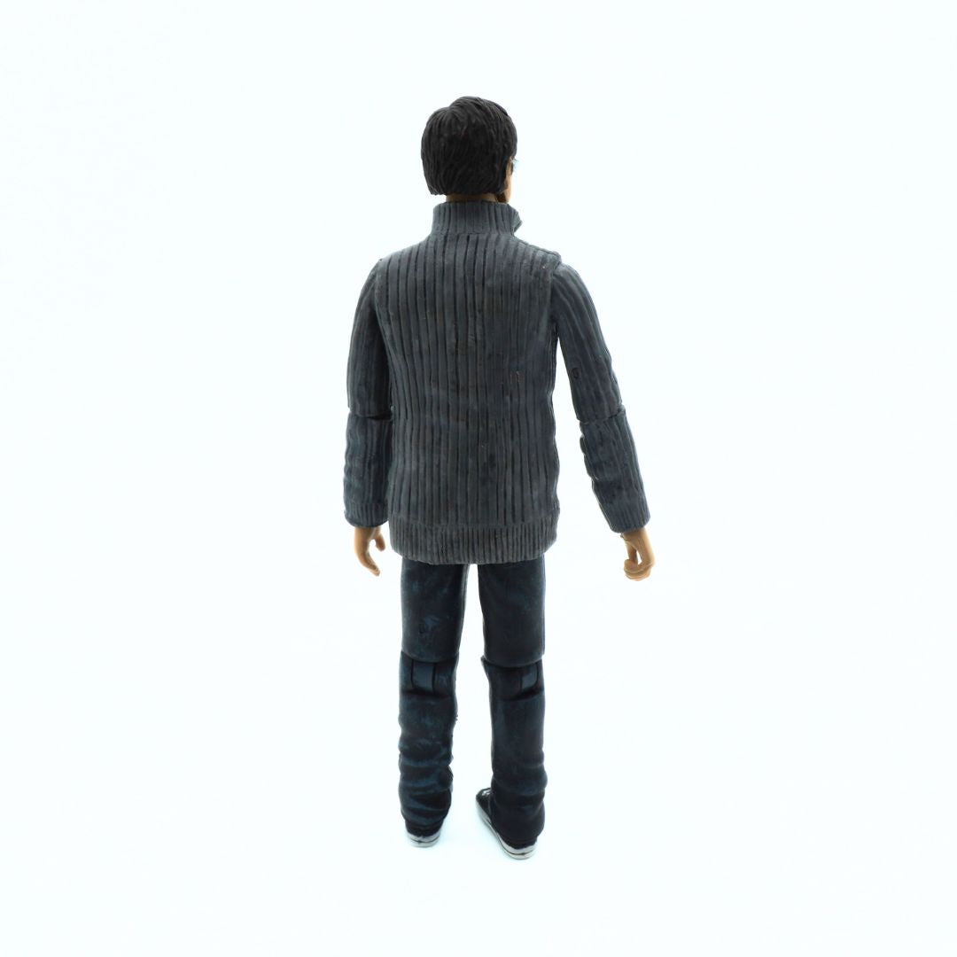 Action figure wearing a gray sweater and dark pants on a white background