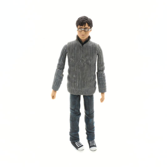 Action figure wearing a gray sweater and jeans on a white background