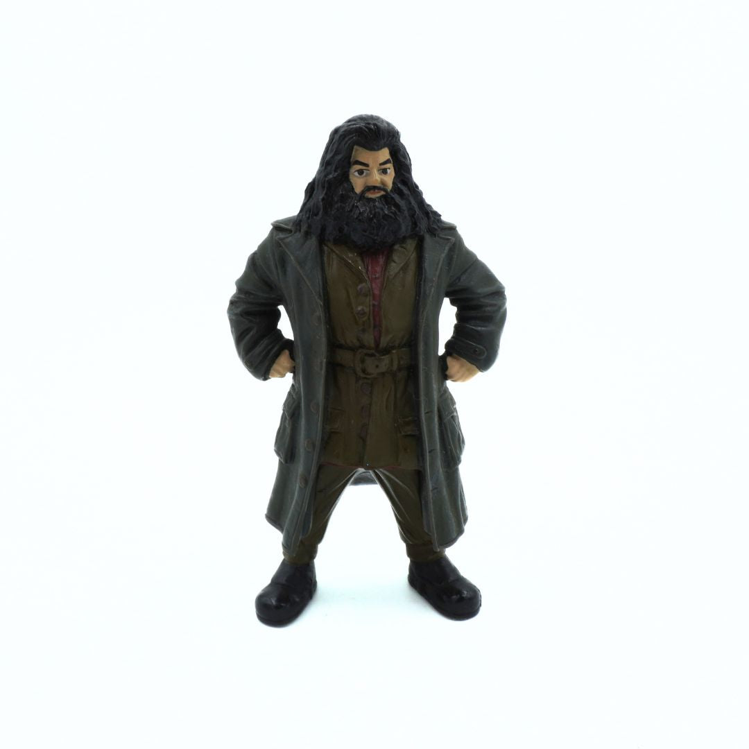 Action figure of a character in a long coat and hat on a white background