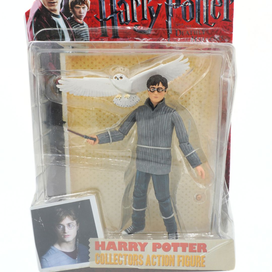 Harry Potter action figure in packaging with a owl and wand