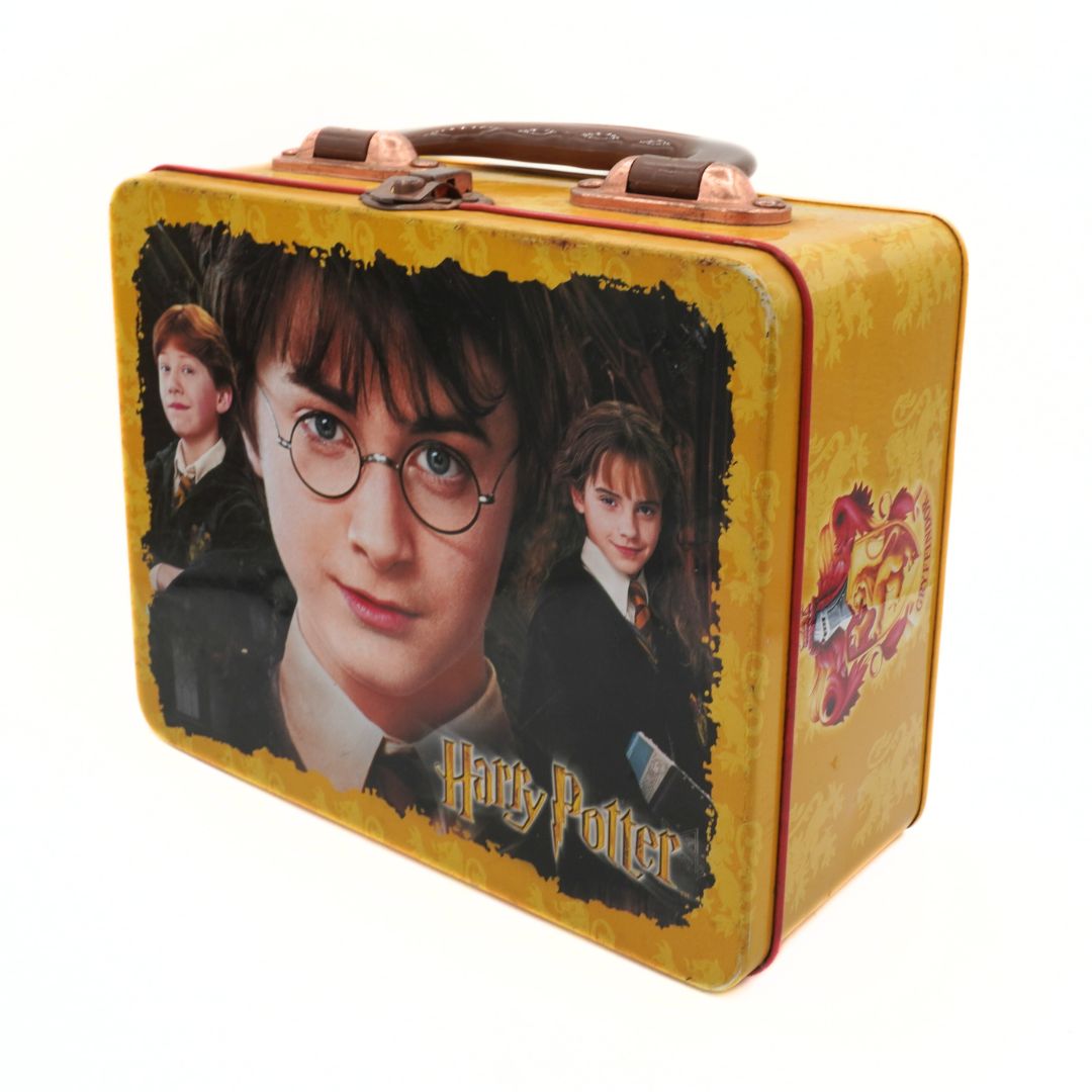 Harry Potter lunchbox with character images on a yellow background