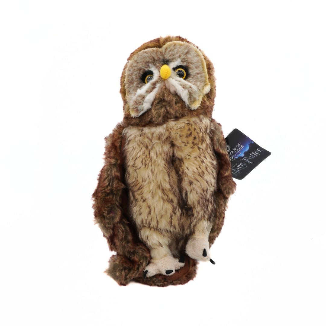 Plush owl toy with a tag on a white background
