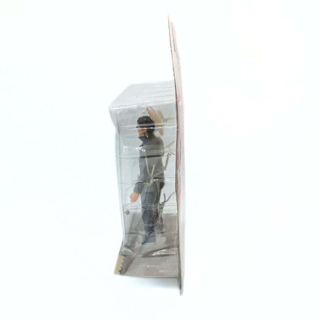 Action figure in a clear plastic packaging on a white background