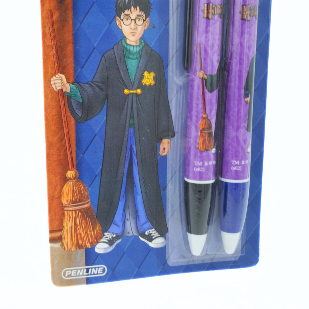 Packaged pens with a character holding a broomstick on a blue background
