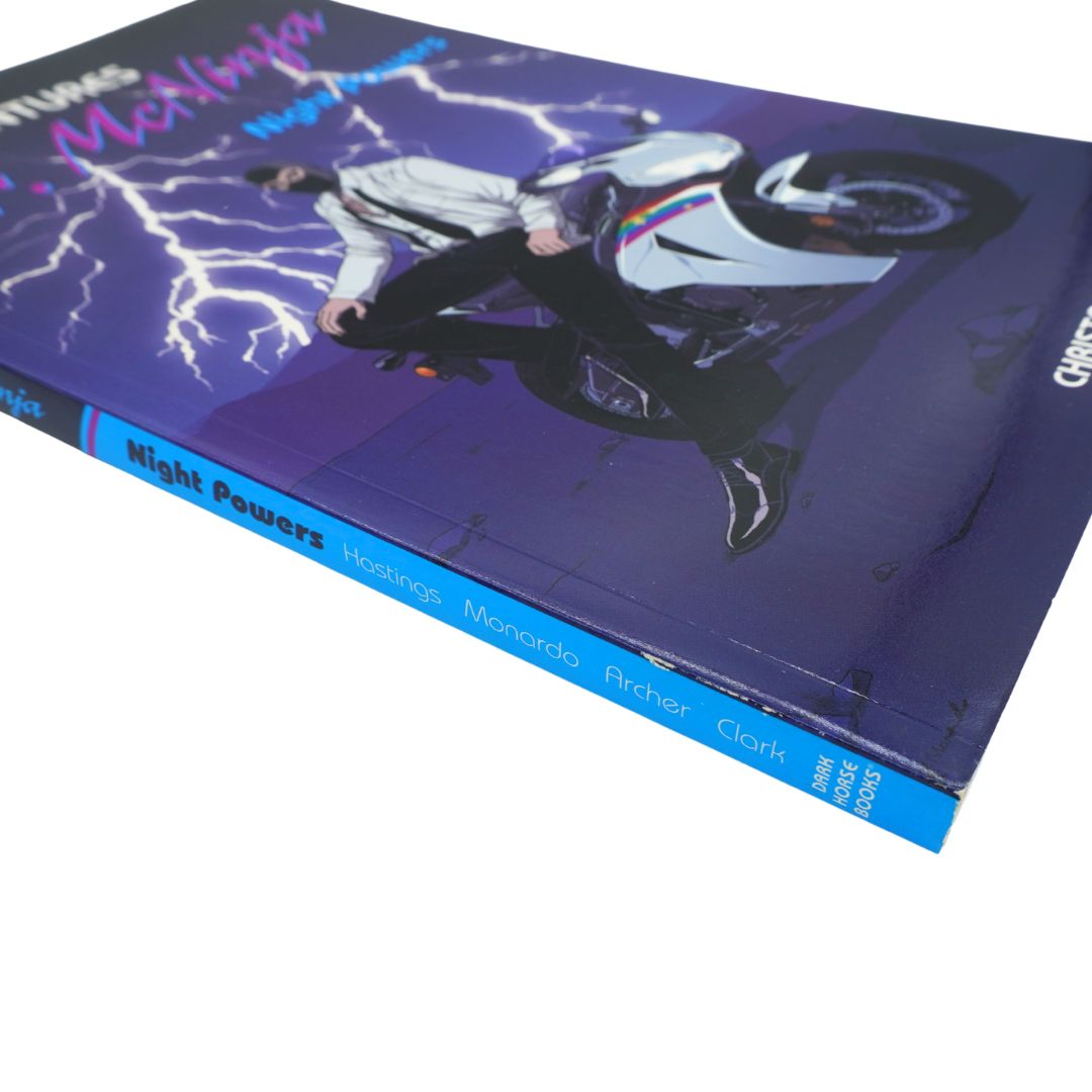 A hardcover book titled 'Night Powers' by Christopher Hastings, featuring a purple cover with a graphic illustration of a man in a white shirt and black pants riding a white motorcycle amidst lightning.