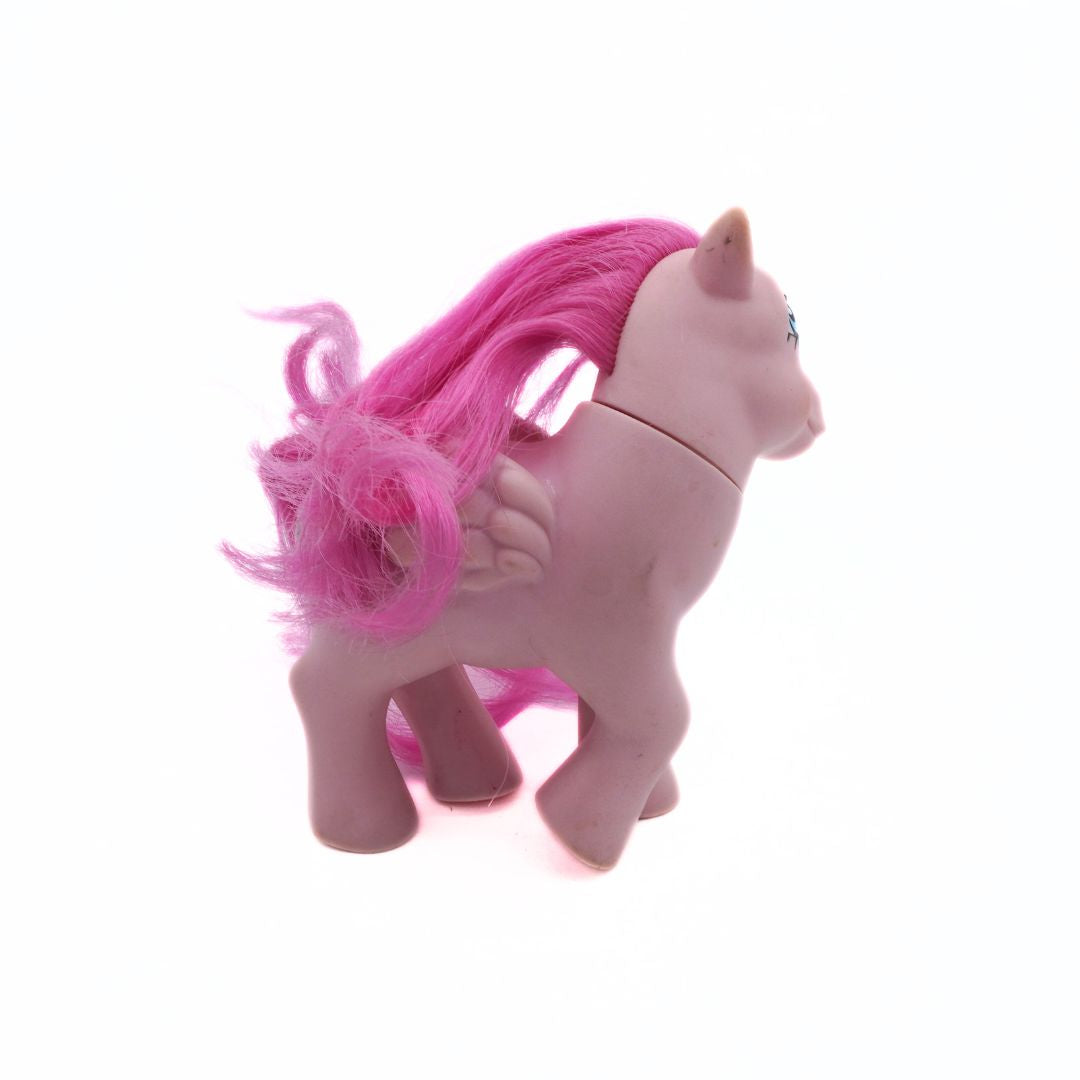 Pink toy unicorn with a bright pink mane on a white background