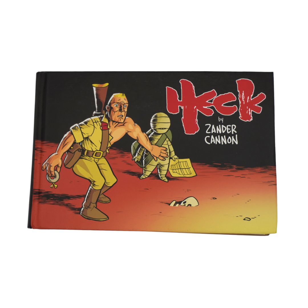 Front cover of the graphic novel Heck by Zander Cannon showing a man in a torn explorers uniform, photographed against a white background