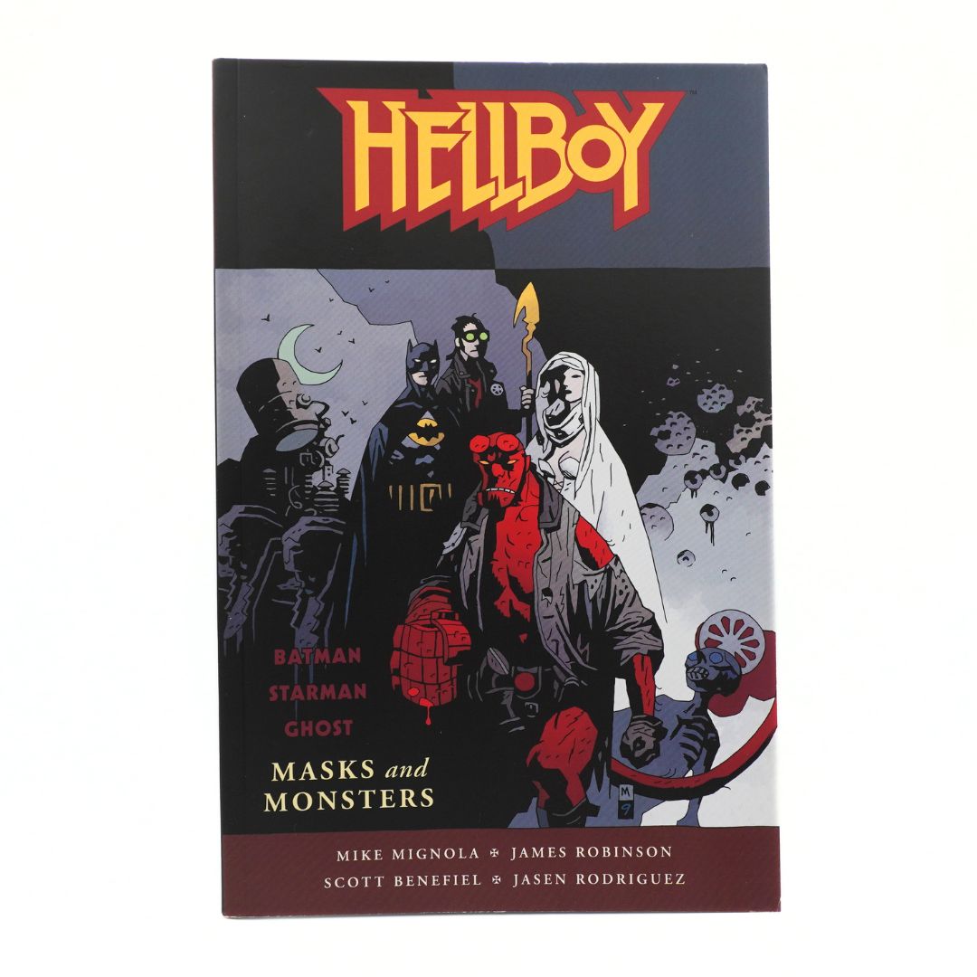 Hellboy: Batman Starman Ghost Masks and Monsters graphic novel volume, featuring a dark illustrated cover with multiple comic characters and the Hellboy title in red and yellow at the top.