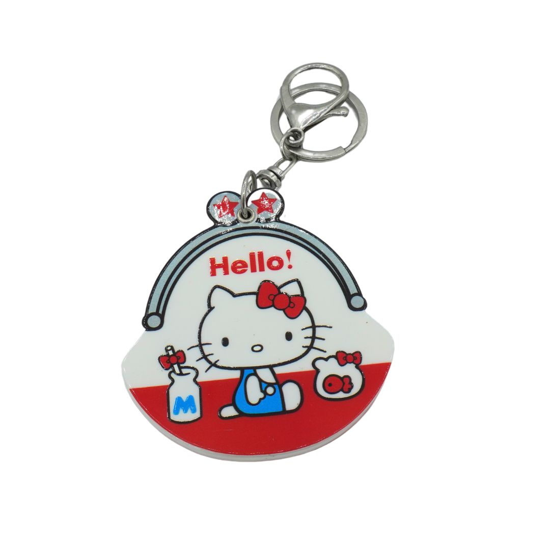 A red and white Hello Kitty keychain photographed on a white background